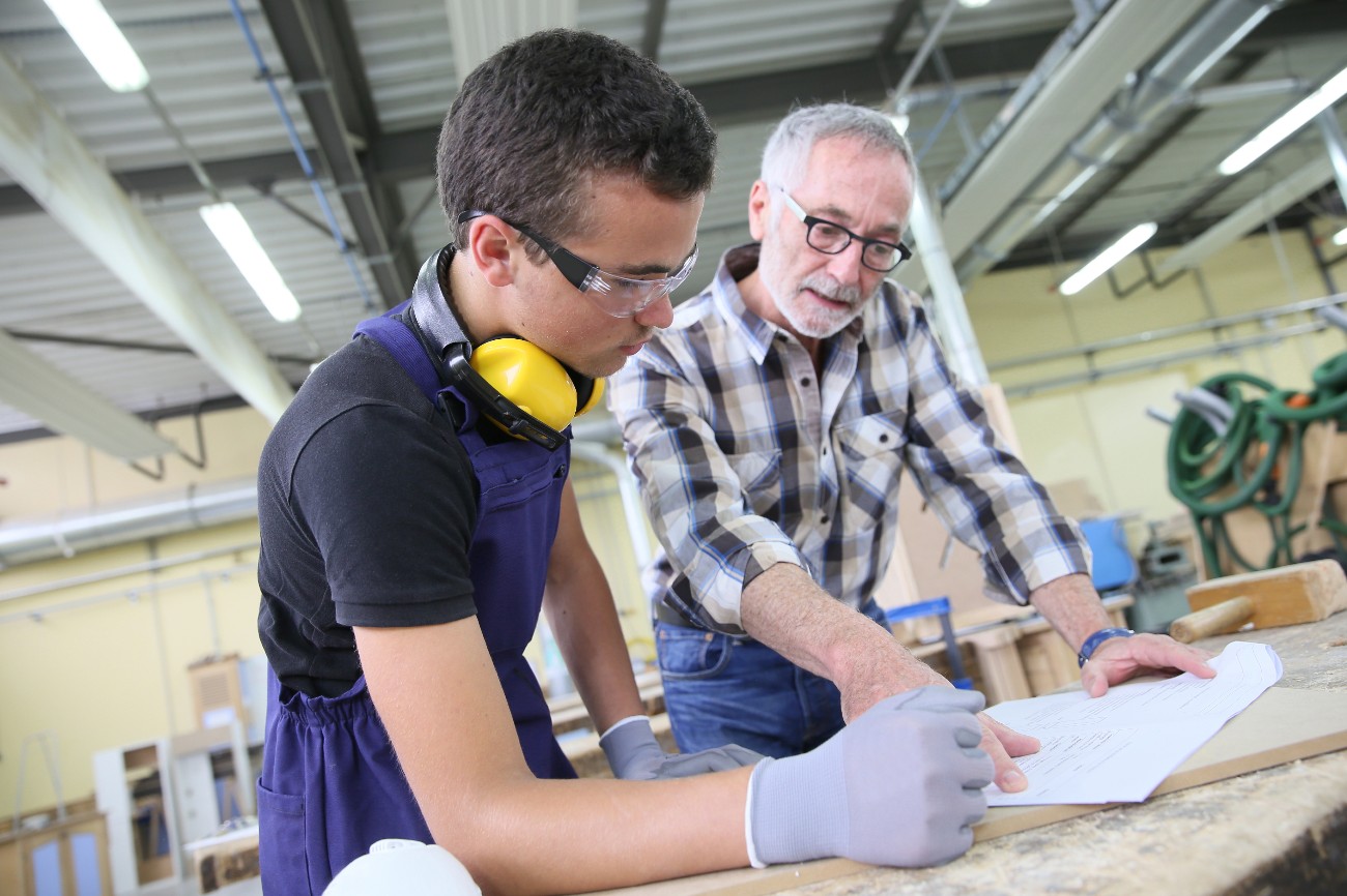 Carpenter with apprentice in training period