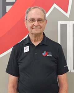 Jim Wissler standing in front of the Build Smart Institute Logo