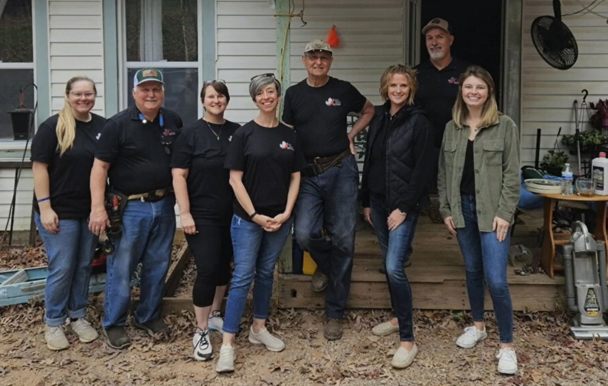 Build Smart team standing in front of an older house.